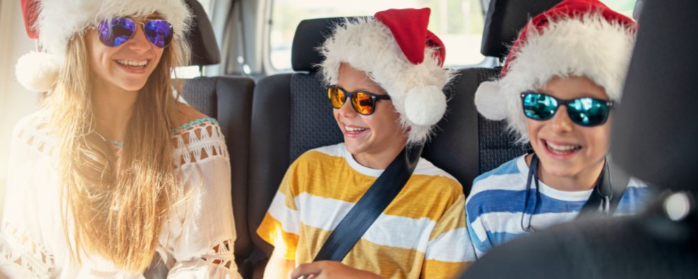 People in santa hats in a van